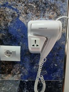 a white phone with a cord plugged into it at Emiljano Seaview in Ksamil