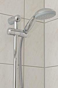 a shower with a shower head in a bathroom at Hotel Weberhof in Zittau