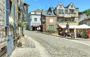 an empty street in a town with buildings and people walking at 2 Bedroom Nice Home In Rendeux in Rendeux