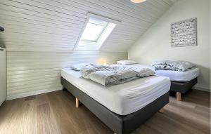 two beds in a room with a attic at 2 Bedroom Nice Home In Rendeux in Rendeux