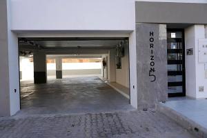 an empty hallway of a building with a parking garage at Un ton Violet in Sfax +2 photos