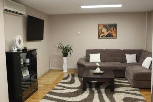 a living room with a couch and a table at Picante apartment in Srbobran