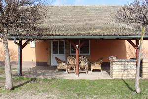 a patio with chairs and tables in front of a house at Picante apartment in Srbobran