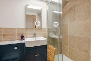 a bathroom with a sink and a glass shower at SkylightAnnex in Gaywood