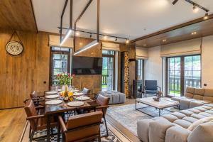a living room with a table and a dining room at Sherwood Chalet in Bukovel