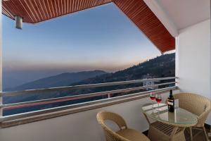 a balcony with a table and chairs and a view at Sunrise Villa in Fagu