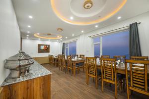 a dining room with a long table and chairs at Sunrise Villa in Fagu