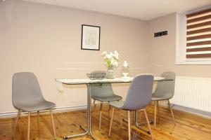 a dining room with a table and four chairs at Picante apartment in Srbobran