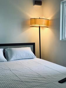 a bedroom with a white bed with a lamp at Greenora Resort in Katunayaka