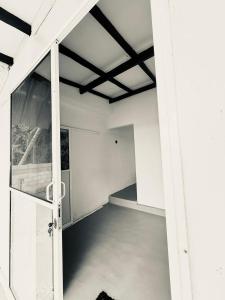 an empty room with an open door in a building at Greenora Resort in Katunayaka