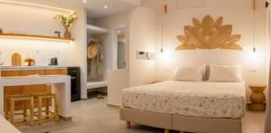 a bedroom with a bed and a kitchen at Panorama Rooms in Anafi