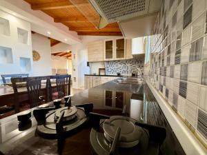 a kitchen with a table and chairs and a counter top at Anel Studios in Vlorë