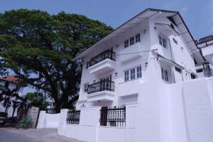 a white building with balconies on the side of it at The Polaris in Cochin