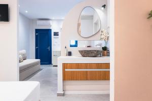 a bathroom with a sink and a mirror at Panorama Rooms in Anafi +86 photos