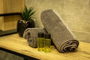 a wooden table with two bottles of essential oils and towels at Gîte Spa Cookie in Urschenheim +36 photos