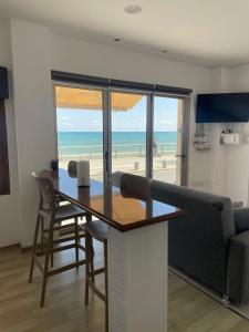 a dining room table with a view of the beach at Seafront Home in Larnaca