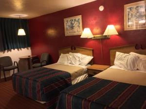 Postel nebo postele na pokoji v ubytování Ranch House Inn & Suites
