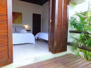 A bed or beds in a room at Pousada Happiness - Ferradura