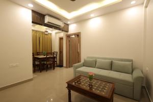 a living room with a couch and a table at Navrasa By CDF in Vrindāvan