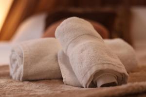 a wrapped up towel on top of a bed at Little Wild - Centre Ville in Saverne