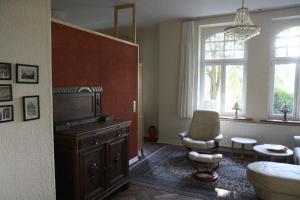 a living room with a piano and a chair at Abschalten und Kraft tanken im Wendland in Schreyahn