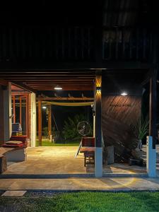 a night view of a patio with a bench at Ponko Home in Ban Si Than