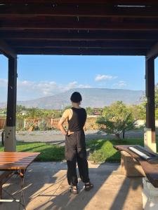 a man standing on a porch looking at a view at Ponko Home in Ban Si Than