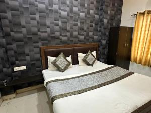 a bedroom with a bed with white sheets and pillows at Hotel Lake View in Varanasi
