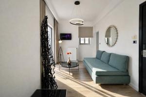 a living room with a blue couch and a table at Areos in Athens