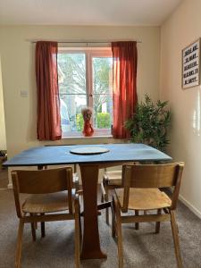 a dining room with a table and two chairs at The Garden Haven in Cheddar