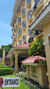 an entrance to a hotel with a sign in front of it at La Casarita in Manila