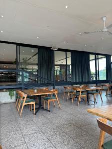 a dining room with wooden tables and windows at Eye with a view in Eikenhof