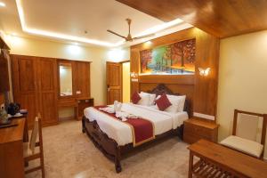 a bedroom with a large bed in a room at Le Kumar Residency in Pondicherry