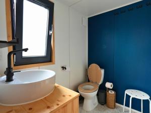 a bathroom with a white sink and a toilet at Tiny Twins - TinyHouse 6 personnes à Malmedy by LaConciergerie in Malmedy +15 photos