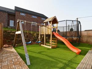 a playground with a slide and a swing at Tiny Twins - TinyHouse 6 personnes à Malmedy by LaConciergerie in Malmedy