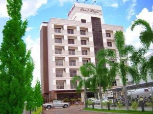 a large building with a car parked in front of it at Pearl Place Hotel in Hat Yai