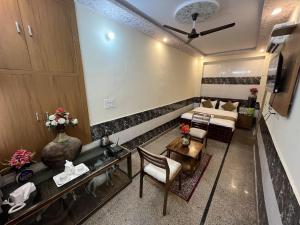 a living room with a couch and a table at Hotel Srinivas in Jodhpur +7 photos