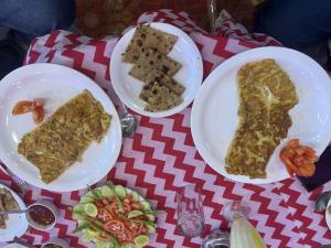 a table with three plates of food on it at Hotel Srinivas in Jodhpur