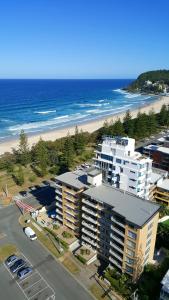 an aerial view of a building and the beach at Wyuna Beachfront Holiday Apartments in Gold Coast