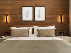 a bedroom with three pictures above a bed at Meerendal Boutique Hotel in Durbanville