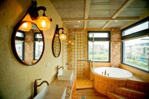 a bathroom with a tub and a sink and a mirror at Kaho Homestay II in Hualien City +80 photos