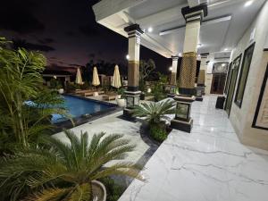 a resort with a swimming pool at night at Villa Bagus in Lovina