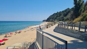 a beach with people on the sand and the ocean at Изгрев-Бяла in Byala