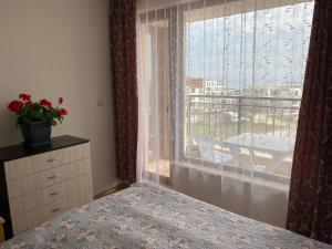 a bedroom with a bed and a window with a view at Изгрев-Бяла in Byala