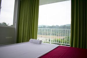 a bedroom with a bed and a large window at The Cliff Kandy in Gonawatta +4 photos