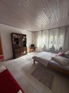 a bedroom with a large bed and windows at Ferien im Bomlitztal in Bomlitz