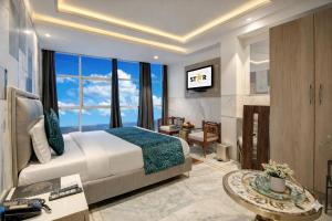 a hotel room with a bed and a large window at Hotel International Inn - Near Delhi Airport in New Delhi +155 photos