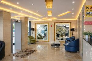 a lobby of a hotel with chairs and a table at Hotel International Inn - Near Delhi Airport in New Delhi