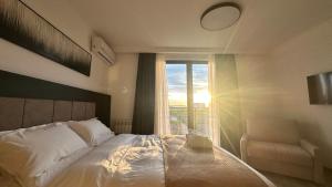 a bedroom with a large bed and a window at KIMMIY HOTEL Garni in Beograd +20 photos