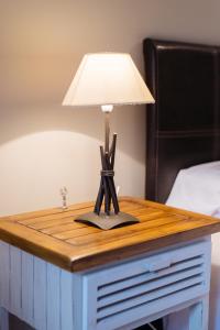 a table with a lamp on top of a bed at Gaudioso by Cardi Suites in Sallent de Gállego